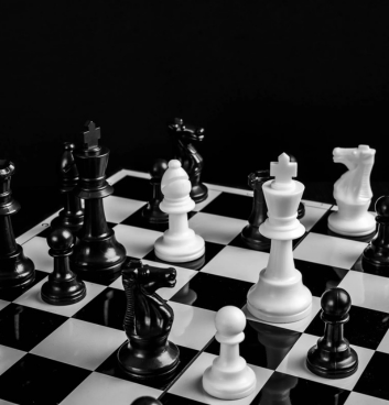 Chess game in progress at Hôtel de la Truite on a black and white chessboard